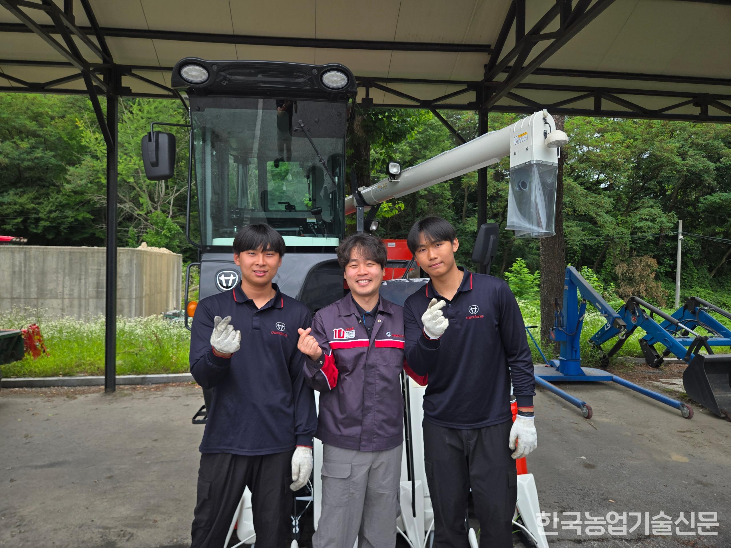 (왼쪽부터) 정연성 군, 황민호 교사, 한두진 군이 야외 실습장에서 손가락 하트를 날리고 있다.